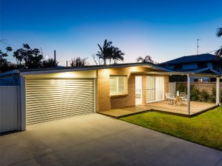 Exterior view of a modern garage door and entrance at sunset, Clinton, UT