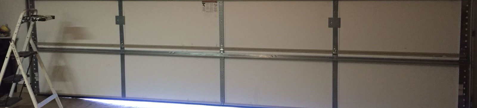 Wide view of white double sectional garage door at Clearfield, UT home with opener malfunction before repair1.